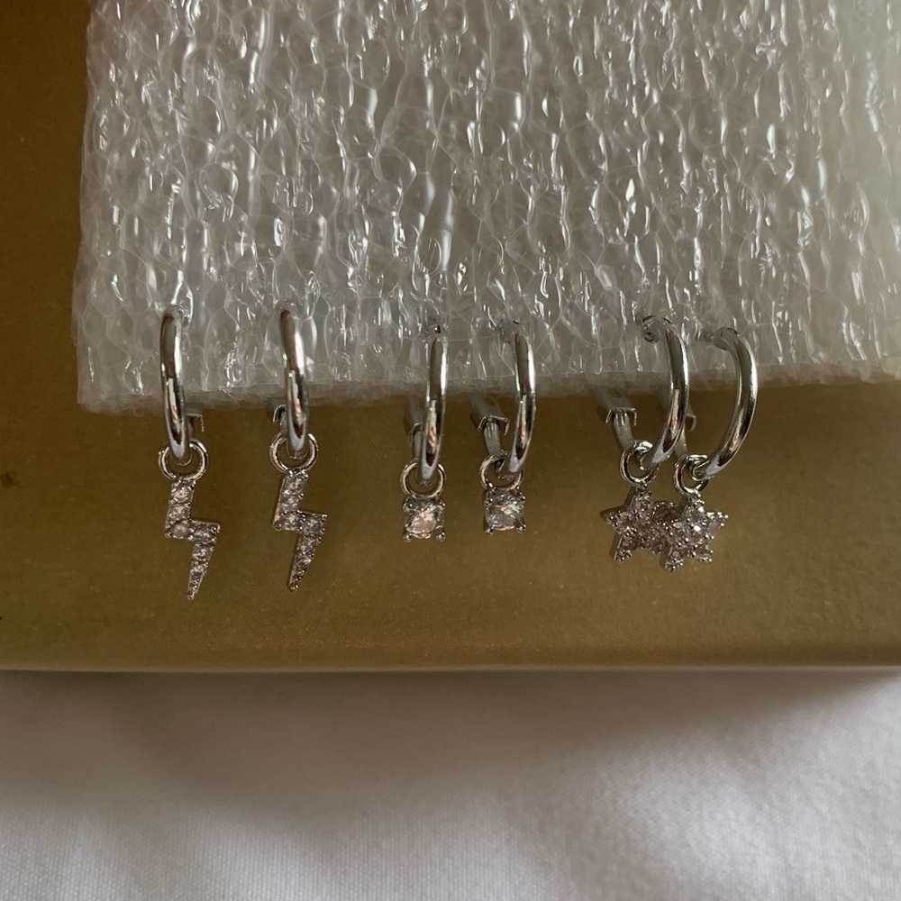 Set Of 3 Silver Baby Hoop Earrings, Charms: Lighting Bolt, Star, And Stud.